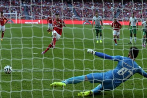 Benfica's Lima, from Brazil, shoots a penalty kick to score his side's third goal past Moreirense's goalkeeper Jose Carlos Marafona, foreground right, during a Portuguese league soccer match between Benfica and Moreirense at Benfica's Luz stadium, in Lisbon, Sunday, Sept. 21, 2014. Lima scored once in Benfica's 3-1 victory. (AP Photo/Francisco Seco)