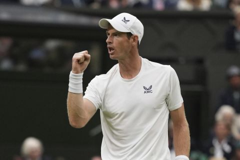 Britain's Andy Murray celebrates winning a point from Britain's Ryan Peniston during the first round men's singles match on day two of the Wimbledon tennis championships in London, Tuesday, July 4, 2023. (AP Photo/Alberto Pezzali)