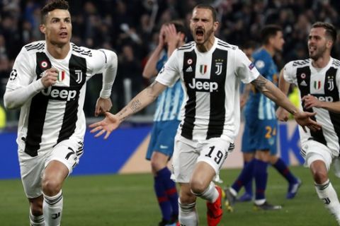 Juventus' Cristiano Ronaldo, left, celebrates after scoring his side's third goal during the Champions League round of 16, 2nd leg, soccer match between Juventus and Atletico Madrid at the Allianz stadium in Turin, Italy, Tuesday, March 12, 2019. (AP Photo/Antonio Calanni)