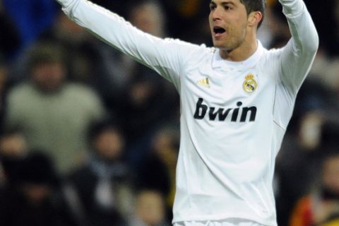Real Madrid's Portuguese forward Cristiano Ronaldo celebrates after scoring his second goal during the Spanish League football match Real Madrid vs Levante at the Santiago Barnabeu stadium in Madrid on February 12, 2012.    AFP PHOTO / PIERRE-PHILIPPE MARCOU (Photo credit should read PIERRE-PHILIPPE MARCOU/AFP/Getty Images)