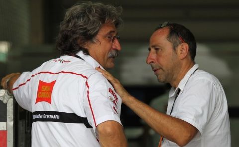 Paulo Simoncelli (L), the father of Honda rider Marco Simoncelli of Italy, is consoled outside a medical centre where the rider was taken following a fatal crash at the Malaysian Grand Prix MotoGP race at Sepang on October 23, 2011. Italy's Marco Simoncelli died of injuries sustained in a crash that resulted in the cancellation of the Malaysian MotoGP, in the latest tragedy to hit motor sports. AFP PHOTO / MOHD RASFAN (Photo credit should read MOHD RASFAN/AFP/Getty Images)