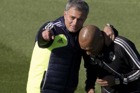 Real Madrid's coach Jose Mourinho of Portugal, left, talks with assistant coach Jose Morais, also of Portugal during training session at the Santiago Bernabeu stadium in Madrid, Monday Nov. 5, 2012. Real Madrid will play Borussia Dortmund Tuesday in a Group D Champions League soccer match.  (AP Photo/Paul White)