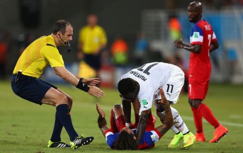 NATAL, BRAZIL - JUNE 16: Sulley Muntari of Ghana reacts angrily after a challenge by Jermaine Jones of the United States as referee Jonas Eriksson runs on during the 2014 FIFA World Cup Brazil Group G match between Ghana and the United States at Estadio das Dunas on June 16, 2014 in Natal, Brazil.  (Photo by Michael Steele/Getty Images)