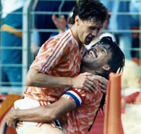 Ruud Gullit of the Netherlands, right, happily smiles at his team mate Marco van Basten, whom he lifts in jubilation after van Basten scored the second goal in the European Soccer Championship game against England on Wednesday, June 15, 1988 in Duesseldorf, Germany. Later van Basten scored again giving the Netherlands a lead of 3-1. (AP Photo)