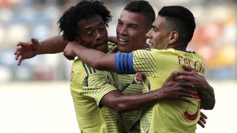 Colombia's Uribe, center, celebrates his goal against Peru with teammates Juan Cuadrado, left, and Radamel Falcao, during a friendly soccer match at Monumental stadium in Lima, Peru, Sunday, June 9, 2019. (AP Photo/Martin Mejia)