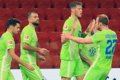 Wolfsburg players celebrate the second goal their team during the second qualifying round soccer match of Europa League between Kukes and Wolfsburg at Arena Kombetare in Tirana, Albania, Thursday, Sept 17, 2020. (AP Photo/Hektor Pustina)