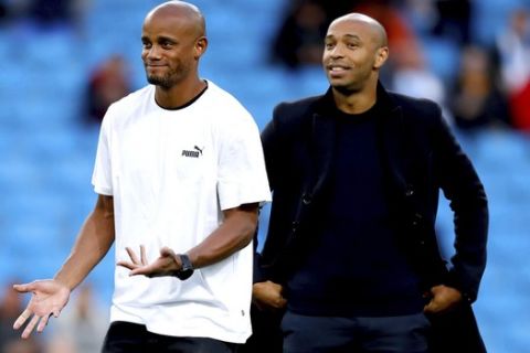 Manchester City's Vincent Kompany, left, and Premier League All Stars XI Assistant Manager Thierry Henry prior to the Vincent Kompany Testimonial at the Etihad Stadium, Manchester, England, Wednesday, Sept. 11, 2019. (Martin Rickett/PA via AP)
