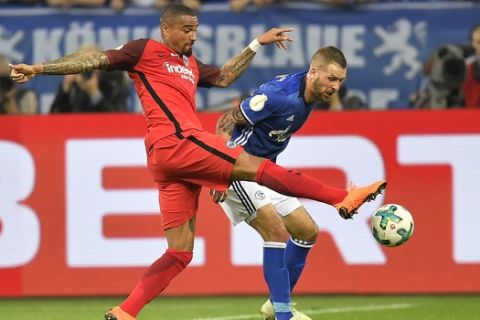 Schalke's Guido Burgstaller and Frankfurt's Kevin-Prince Boateng challenge for the ball during the German soccer cup semifinal match between FC Schalke 04 and Eintracht Frankfurt in Gelsenkirchen, Germany, Wednesday, April 18, 2018. (AP Photo/Martin Meissner)