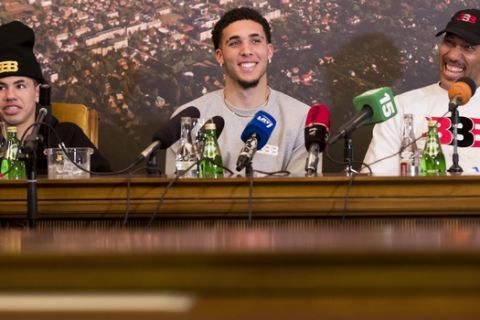 American basketball players LiAngelo Ball, center, and LaMelo Ball, left, and their father LaVar Ball participates in a media conference at the Harmony park hotel in Vaizgaikiemis village, Prienai district, Lithuania, Friday, Jan. 5, 2018. LiAngelo Ball and LaMelo Ball have both signed a one-year contracts to play for Lithuanian professional basketball club Prienai - Birstonas Vytautas in the southern Lithuania town of Prienai, some 110 km (68 miles) from the Lithuanian capital Vilnius.(AP Photo/Mindaugas Kulbis)