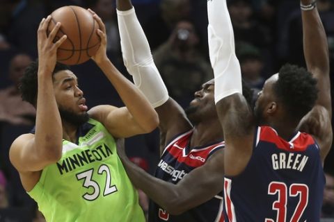 Minnesota Timberwolves' Karl-Anthony Towns, left, is double-teamed by Washington Wizards' Bobby Portis, center, and Jeff Green in the second half of an NBA basketball game Saturday, March 9, 2019, in Minneapolis. (AP Photo/Jim Mone)