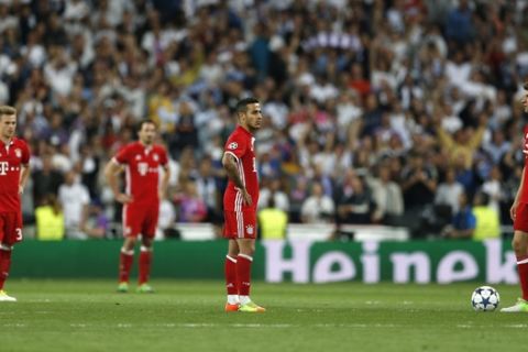 Bayern players stand defeated on the pitch after losing the Champions League quarterfinal second leg soccer match between Real Madrid and Bayern Munich with a 4-2 score at Santiago Bernabeu stadium in Madrid, Spain, Tuesday April 18, 2017. (AP Photo/Francisco Seco)