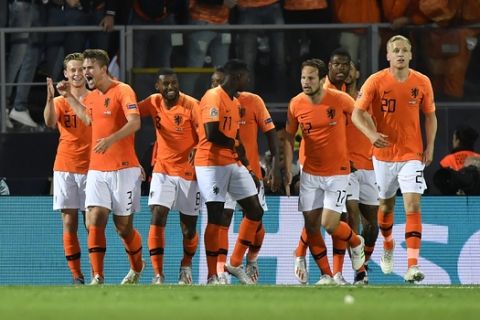 Netherlands' Matthijs de Ligt, third left, celebrates with his teammates after scoring his side's opening goal during the UEFA Nations League semifinal soccer match between Netherlands and England at the D. Afonso Henriques stadium in Guimaraes, Portugal, Thursday, June 6, 2019. (AP Photo/Martin Meissner)