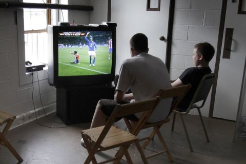 In the basement of the Alta House community center in Cleveland's Little Italy neighborhood, brothers Ambrose, left, 15, and Blaise DeRoberts, 12, watch on television as Italy takes on Paraguay in the soccer World Cup, on Monday, June 14, 2010. (AP Photo/Amy Sancetta)