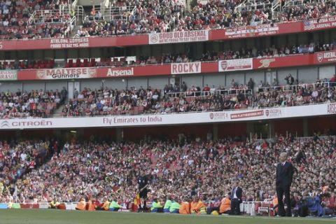 Arsenal manager Arsene Wenger looks across the pitch during the English Premier League soccer match between Arsenal and Everton at The Emirates stadium in London, Sunday May 21, 2017. (AP Photo/Tim Ireland)