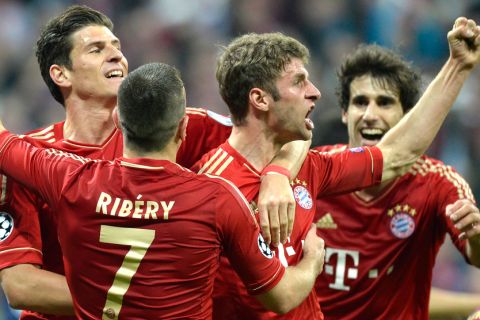 Bayern Munich's midfielder Thomas Mueller (2dR) celebrates scoring a goal with teammates striker Mario Gomez (L) and French midfielder Franck Ribery (C) during the UEFA champions league semi final first leg football match FC Bayern Muenchen vs FC Barcelona on April 23, 2013 in Munich, southern Germany.  AFP PHOTO CHRISTOF STACHE        (Photo credit should read CHRISTOF STACHE/AFP/Getty Images)