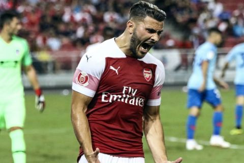 Arsenal's Sead Kolasinac reacts after missing a shot attempt during the International Champions Cup match between Arsenal and Atletico Madrid in Singapore, Thursday, July 26, 2018. (AP Photo/Yong Teck Lim)