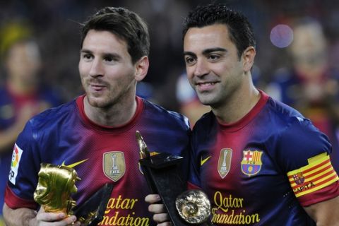 FC Barcelona's Lionel Messi from Argentina, left, hold the European Golden Boot 2012 award for best European goalscorer of the 2011-2012 season and Xavi Hernandez holds the Spain's prestigious Asturias prize before a Spanish La Liga soccer match a at the Camp Nou stadium in Barcelona, Spain, Saturday, Nov. 3, 2012. (AP Photo/Manu Fernandez)