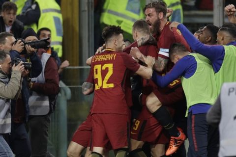 Roma players celebrate first goal during an Italian Serie A soccer match between AS Roma and Lazio, at the Olympic stadium in Rome, Saturday, Nov. 18, 2017. (AP Photo/Andrew Medichini)