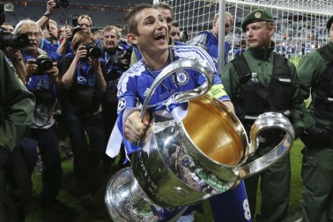 Chelsea's Frank Lampard holds the trophy at the end of the Champions League final soccer match between Bayern Munich and Chelsea in Munich, Germany Saturday May 19, 2012. Chelsea's Didier Drogba scored the decisive penalty in the shootout as Chelsea beat Bayern Munich to win the Champions League final after a dramatic 1-1 draw on Saturday. (AP Photo/Matt Dunham)