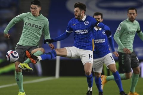 Everton's James Rodriguez, left, vie for the ball with Brighton's Adam Lallana during the English Premier League soccer match between Brighton and Everton at the Falmer Stadium in Brighton, England, Monday, April 12, 2021. (Glyn Kirk/Pool via AP)
