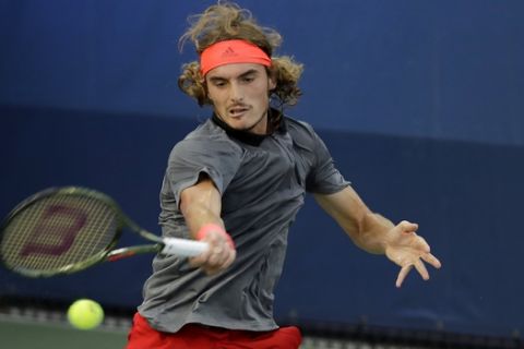 Stefanos Tsitsipas, of Greece, returns a shot to Tommy Robredo, of Spain, during the first round of the U.S. Open tennis tournament, Monday, Aug. 27, 2018, in New York. (AP Photo/Kevin Hagen)