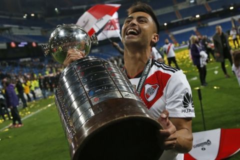 Gonzalo Martinez of Argentina's River Plate holds the trophy after defeating Argentina's Boca Juniors 3-1 in the Copa Libertadores final soccer match at the Santiago Bernabeu stadium in Madrid, Spain, Sunday, Dec. 9, 2018. (AP Photo/Andrea Comas)