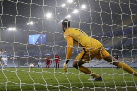 Manchester City's Kevin De Bruyne, left, fails to score a penalty shot during the English Premier League soccer match between Manchester City and Liverpool at the Etihad stadium in Manchester, England, Sunday, Nov. 8, 2020. (Clive Brunskill/Pool via AP)