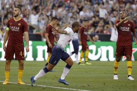 Tottenham midfielder Lucas Moura, center, celebrates after scoring a goal as Roma's Konstantinos Manolas, left, and Juan Jesus, right, react during the first half of an International Champions Cup tournament soccer match Wednesday, July 25, 2018, in San Diego. (AP Photo/Gregory Bull)