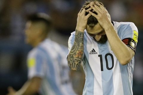 Argentinas Lionel Messi reacts after missing a chance to score during a 2018 Russia World Cup qualifying soccer match between Argentina and Chile at the Monumental stadium in Buenos Aires, Argentina, Thursday March 23, 2017. At left is Argentinas Lionel Messi. (AP Photo/Victor R. Caivano)