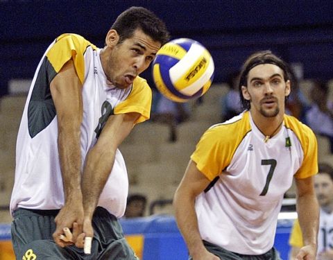 Brazil's Dante Guimaraes Amaral (18) sets the ball with Gilberto Godoy Filho (7) watching during their preliminary round volleyball match against Netherlands at the 2004 Olympics Games in Athens, Thursday, Aug. 19, 2004. Brazil won 25-22, 24-26, 25-21, 25-19. (AP Photo/Morry Gash)