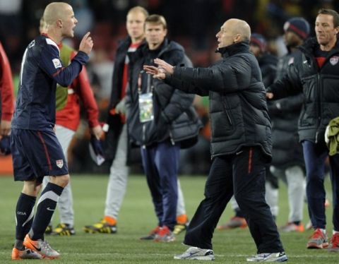 United States' Michael Bradley, left, speaks with his father United States head coach Bob Bradley, center right, after the World Cup group C soccer match between Slovenia and the United States at Ellis Park Stadium in Johannesburg, South Africa, Friday, June 18, 2010. The match ended in a 2-2 draw.(AP Photo/Martin Meissner)