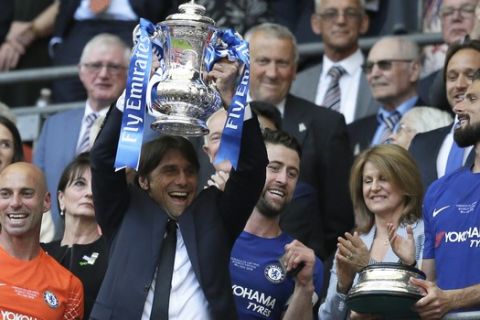Chelsea head coach Antonio Conte lifts the trophy after winning the English FA Cup final soccer match between Chelsea and Manchester United at Wembley stadium in London, Saturday, May 19, 2018. Chelsea defeated Manchester United 1-0. (AP Photo/Tim Ireland)