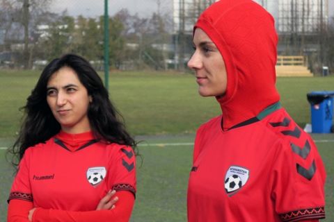 Afghani national soccer team player Shabnam Mabarz, right, wearing the new head-to-toe outfit with an integrated hijab, stands next to Khalida Popal, the former Afghanistan national women's team captain, in Copenhagen on Tuesday, March 8, 2016. The new Afghanistan national women's soccer team uniform was revealed on Tuesday, featuring an integrated hijab. (AP Photos/Jan M. Olsen)