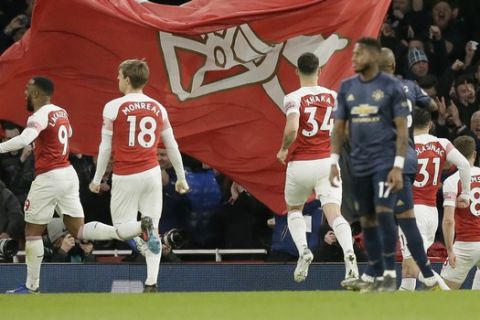Arsenal players celebrate after Arsenal's Pierre-Emerick Aubameyang scored his side's second goal during the English Premier League soccer match between Arsenal and Manchester United at the Emirates Stadium in London, Sunday, March 10, 2019. (AP Photo/Tim Ireland)