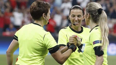 Assistant referee Michelle O'Neill of Ireland, Referee Stephanie Frappart and Assistant referee Manuela Nicolosi of France, from left to right, shake hands before the start of the UEFA Super Cup soccer match between Liverpool and Chelsea, in Besiktas Park, in Istanbul, Wednesday, Aug. 14, 2019. (AP Photo/Thanassis Stavrakis)