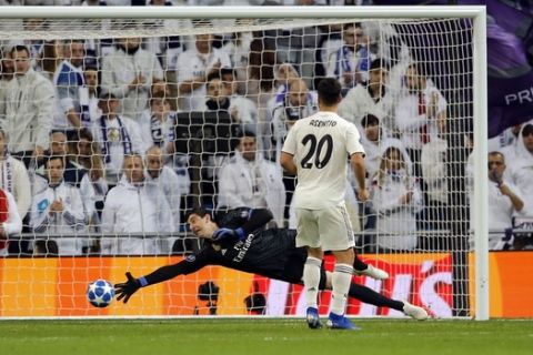 Real goalkeeper Thibaut Courtois fils to block a shot by CSKA midfielder Arnor Sigurdsson during the Champions League, Group G soccer match between Real Madrid and CSKA Moscow, at the Santiago Bernabeu stadium in Madrid, Spain, Wednesday Dec. 12, 2018. (AP Photo/Paul White)