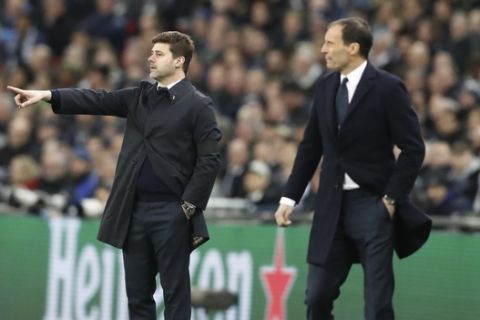 Tottenham coach Mauricio Pochettino gestures, left, as Juventus coach Massimiliano Allegri stands during the Champions League, round of 16, second-leg soccer match between Juventus and Tottenham Hotspur, at the Wembley Stadium in London, Wednesday, March 7, 2018. (AP Photo/Frank Augstein)