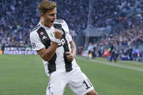 Juventus' Paulo Dybala celebrates after scoring his side's opening goal during the Champions League, group H soccer match between Juventus and Young Boys, at the Allianz stadium in Turin, Italy, Tuesday, Oct. 2, 2018. (AP Photo/Luca Bruno)