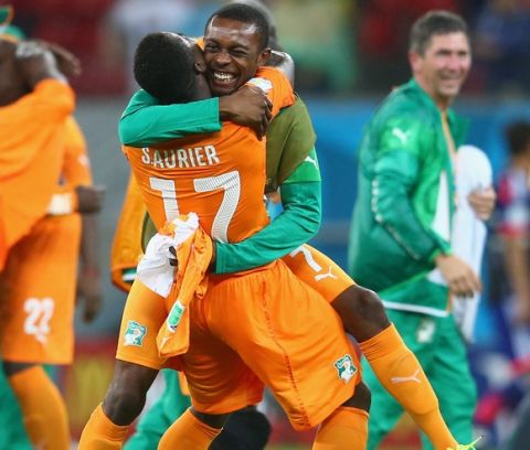 RECIFE, BRAZIL - JUNE 14: Serge Aurier of the Ivory Coast (L) and Jean-Daniel Akpa-Akpro of the Ivory Coast hug after defeating Japan 2-1 during the 2014 FIFA World Cup Brazil Group C match  between the Ivory Coast and Japan at Arena Pernambuco on June 14, 2014 in Recife, Brazil.  (Photo by Julian Finney/Getty Images)
