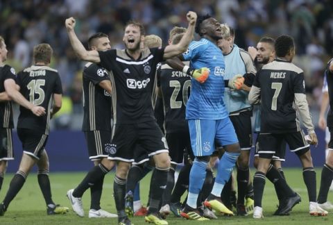 Ajax's players celebrate the victory after their Champions League, play-off round, second leg soccer match between Dynamo Kiev and Ajax Amsterdam at the Olympiyskiy stadium in Kiev, Ukraine, Tuesday, Aug. 28, 2018. (AP Photo/Efrem Lukatsky)
