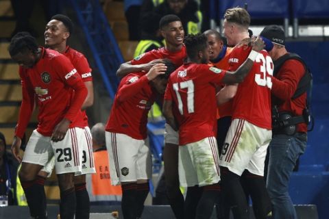 Manchester United's Marcus Rashford, background center, celebrates after scoring his side's second goal during the English League Cup soccer match between Chelsea and Manchester United at Stamford Bridge in London, Wednesday, Oct. 30, 2019. (AP Photo/Ian Walton)