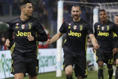 Juventus' Cristiano Ronaldo, left, celebrates with his teammates after scoring his side's second goal during the Serie A soccer match between Lazio and Juventus at the Olympic stadium, in Rome, Sunday, Jan. 27, 2019. (AP Photo/Gregorio Borgia)