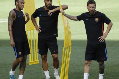 Barcelona's Neymar, left, Luis Suarez, center, and Lionel Messi look on during a training session ahead of an International Champions Cup soccer match against Juventus, Friday, July 21, 2017, in Harrison, N.J. (AP Photo/Julio Cortez)