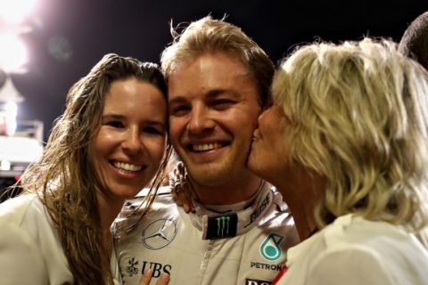 ABU DHABI, UNITED ARAB EMIRATES - NOVEMBER 27:  Nico Rosberg of Germany and Mercedes GP is congratulated on securing the F1 World Drivers Championship by his wife Vivian Sibold and mother Sina Rosberg during the Abu Dhabi Formula One Grand Prix at Yas Marina Circuit on November 27, 2016 in Abu Dhabi, United Arab Emirates.  (Photo by Mark Thompson/Getty Images)