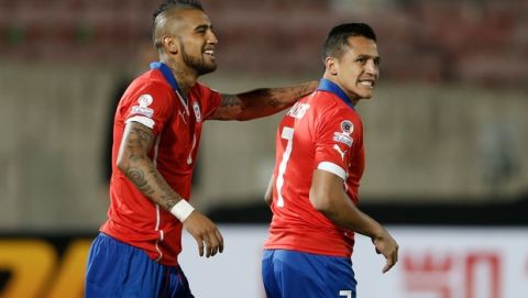 Chile's Alexis Sanchez, right, is comforted by his teammate Arturo Vidal after he missing a chance to score against Ecuador  during a Copa America Group 1 soccer match at the National Stadium in Santiago, Chile, Thursday, June 11, 2015.(AP Photo/Silvia Izquierdo)