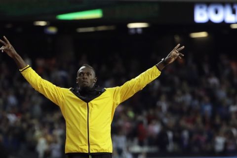 Jamaica's Usain Bolt gestures to the crowd during a victory lap to mark his athletics career during the World Athletics Championships in London Sunday, Aug. 13, 2017. (AP Photo/David J. Phillip)