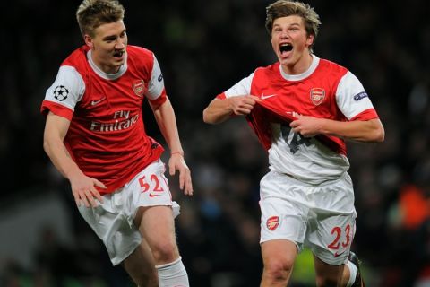 Arsenal's Russian midfielder Andrey Arshavin (R) celebrates after scoring a goal during the Champions League round of 16 first leg football match Arsenal vs FC Barcelona on February 16, 2011 at the Emirates stadium in London.  AFP PHOTO / LLUIS GENE (Photo credit should read LLUIS GENE/AFP/Getty Images)