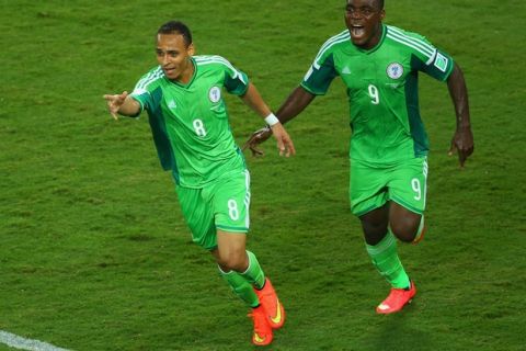 CUIABA, BRAZIL - JUNE 21: Peter Odemwingie of Nigeria (L) celebrates scoring his team's first goal with teammate Emmanuel Emenike during the 2014 FIFA World Cup Group F match between Nigeria and Bosnia-Herzegovina at Arena Pantanal on June 21, 2014 in Cuiaba, Brazil.  (Photo by Clive Brunskill/Getty Images)