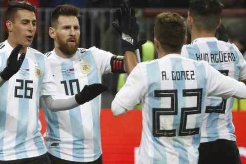Argentina's Sergio Aguero (9) celebrates with team mates Alejandro Gomez (22), Cristian Pavon (26) and Lionel Messi (10) after scoring his side's opening goal during the international friendly soccer match between Russia and Argentina at Luzhniki World Cup 2018 stadium in Moscow, Russia, Saturday, Nov. 11, 2017. (AP Photo/Pavel Golovkin)