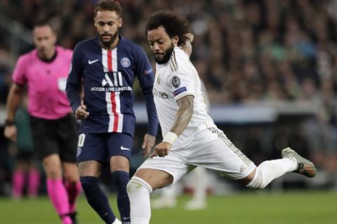 Real Madrid's Marcelo fights for the ball against PSG's Neymar during a Champions League soccer match Group A between Real Madrid and Paris Saint Germain at the Santiago Bernabeu stadium in Madrid, Spain, Tuesday, Nov. 26, 2019. (AP Photo/Bernat Armangue)